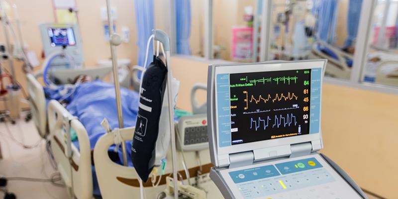 Intensive care room with machines surrounding a hospital bed