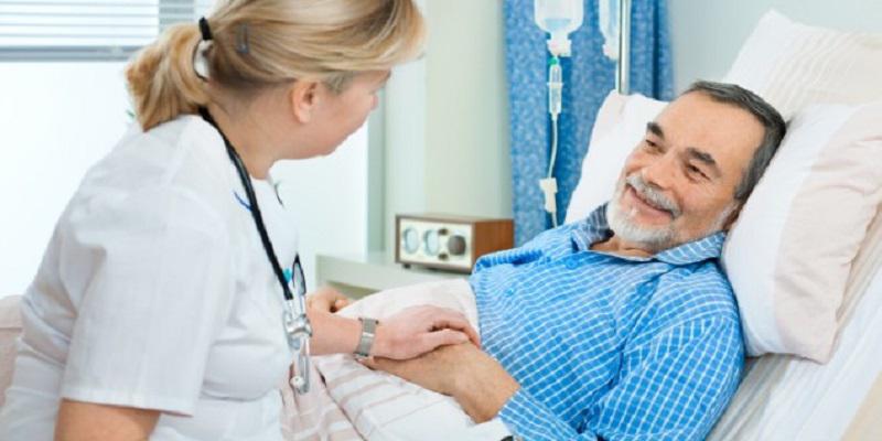 Doctor talking to patient in a bed